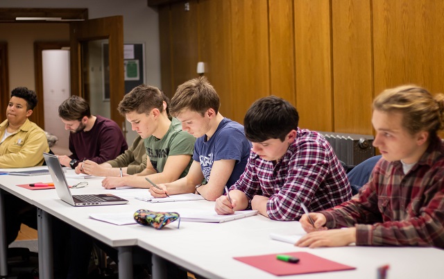 Students working together around a table.